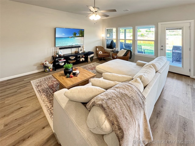 living room featuring ceiling fan and hardwood / wood-style flooring