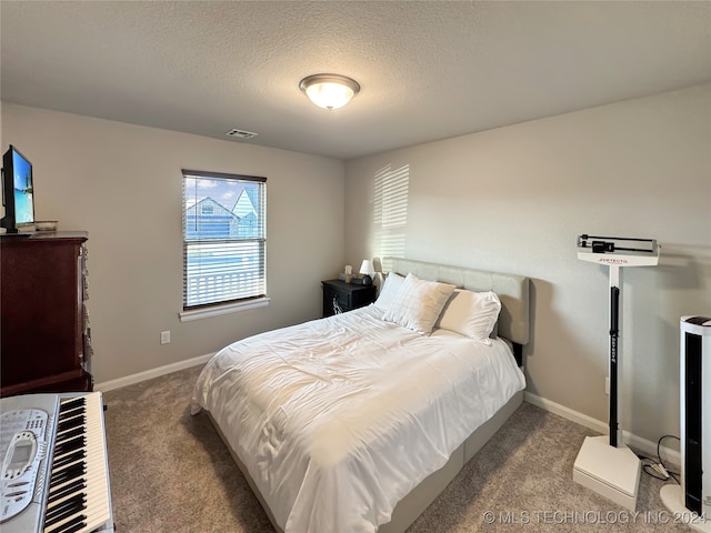 carpeted bedroom with a textured ceiling