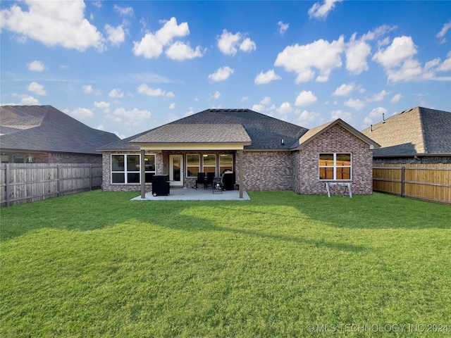 back of house featuring a yard and a patio area