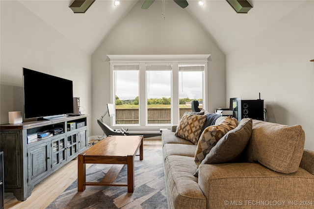 living room featuring ceiling fan, light hardwood / wood-style flooring, and high vaulted ceiling