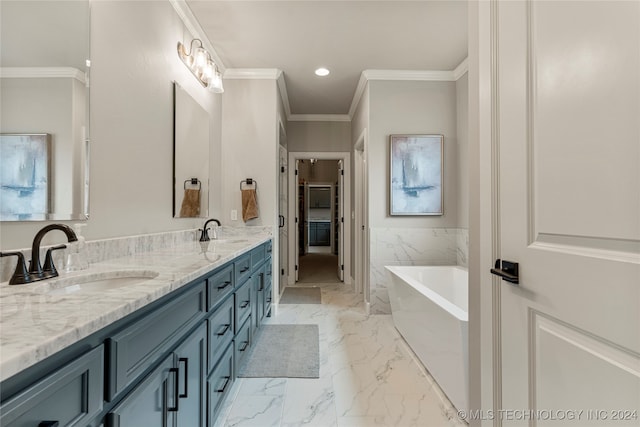 bathroom with vanity, ornamental molding, and a washtub