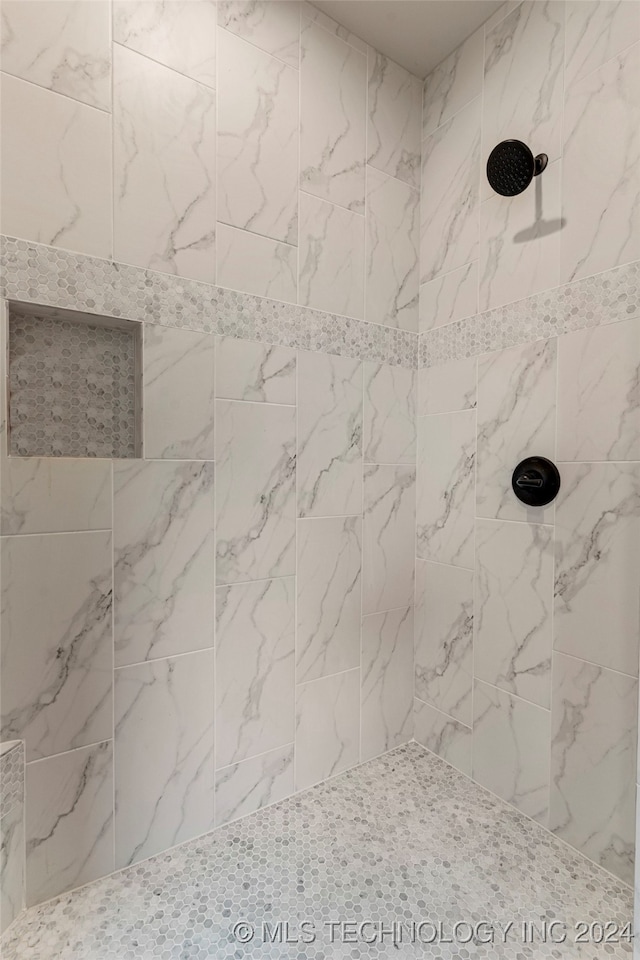 bathroom with tiled shower