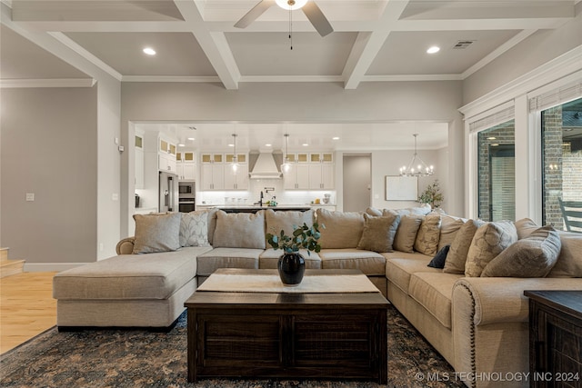 living room featuring coffered ceiling, ceiling fan with notable chandelier, beam ceiling, and dark hardwood / wood-style flooring