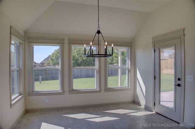 unfurnished dining area featuring an inviting chandelier, lofted ceiling, plenty of natural light, and light tile patterned floors