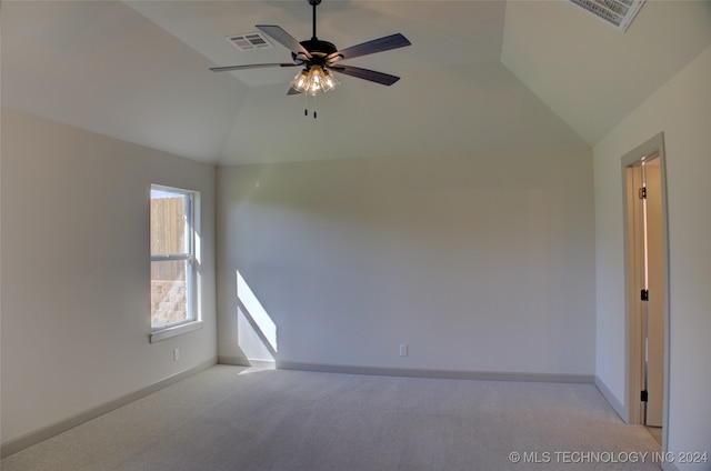 unfurnished room featuring ceiling fan, light colored carpet, and vaulted ceiling