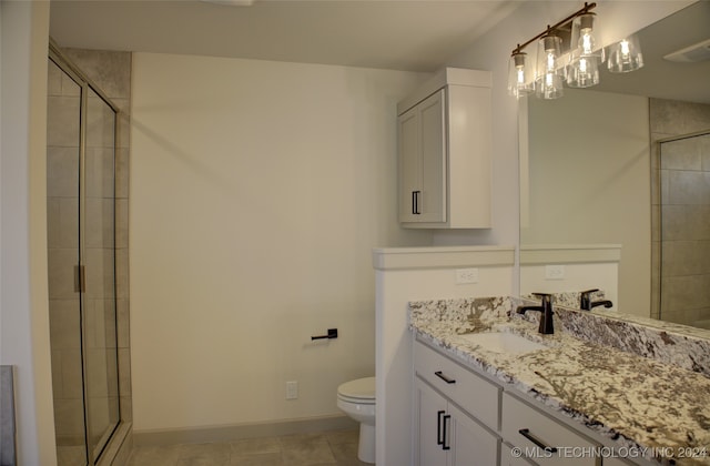 bathroom featuring walk in shower, vanity, tile patterned flooring, and toilet