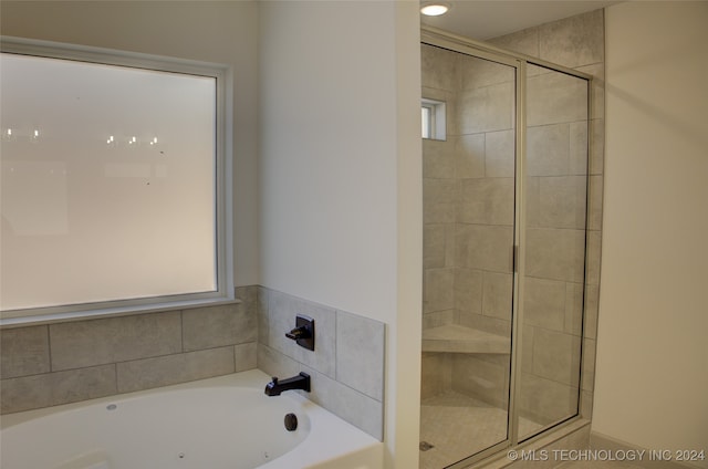 bathroom with a healthy amount of sunlight and plus walk in shower