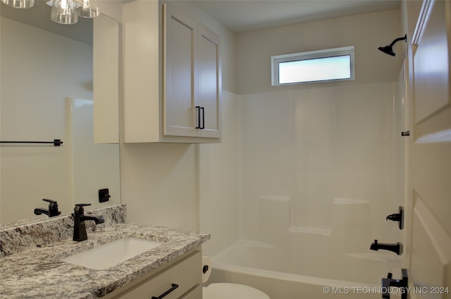 full bathroom featuring shower / bathing tub combination, vanity, and toilet