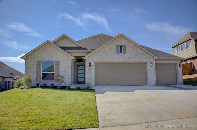 view of front of house with a garage and a front lawn