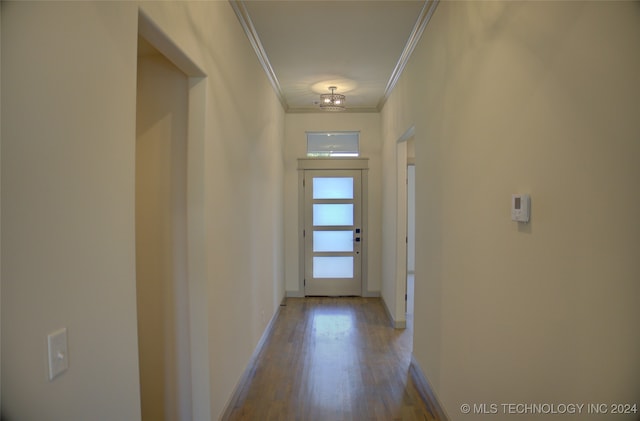 hall with light hardwood / wood-style flooring and crown molding