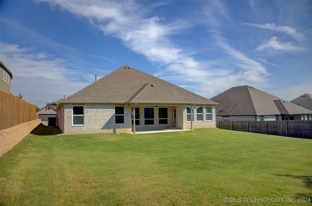 rear view of property with a patio area and a yard