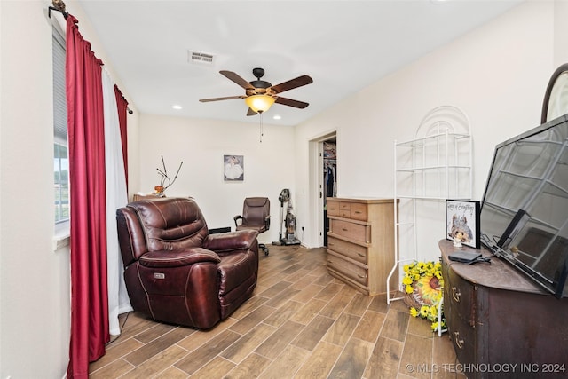 living area with ceiling fan