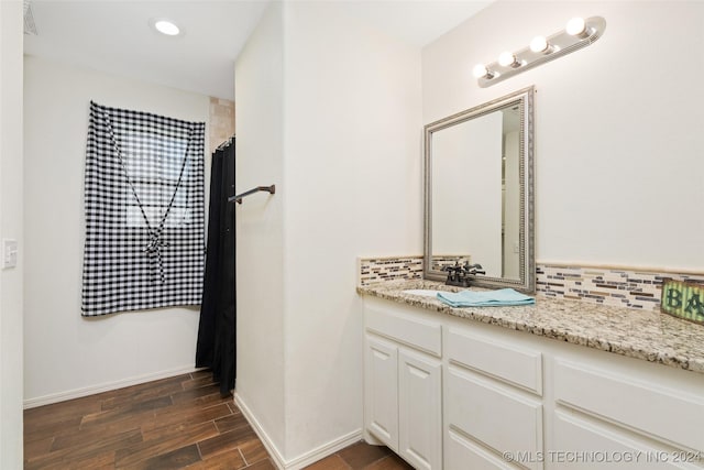 bathroom with a shower with curtain, tasteful backsplash, and vanity