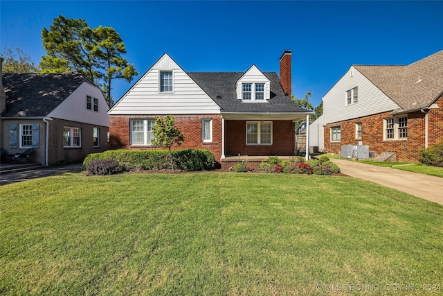 new england style home featuring a front yard