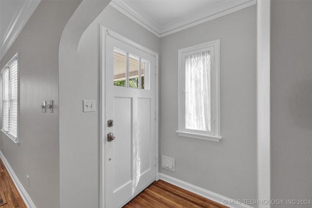 entrance foyer featuring dark wood-type flooring and crown molding