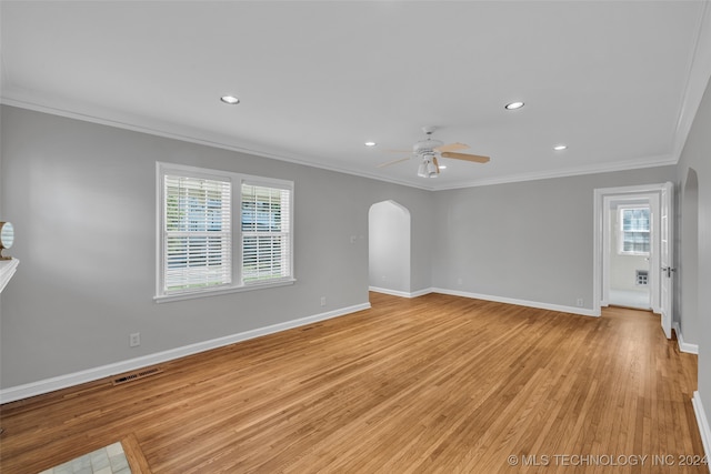 spare room with ceiling fan, light wood-type flooring, and a wealth of natural light