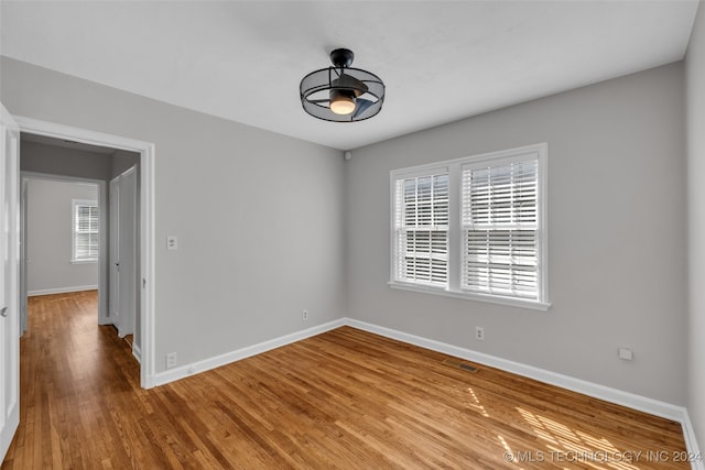 spare room with ceiling fan and light hardwood / wood-style floors