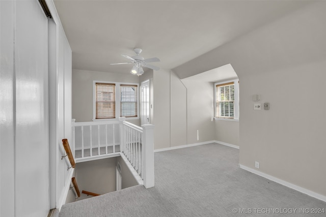 interior space with a healthy amount of sunlight and light carpet