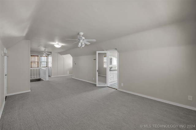 unfurnished living room featuring carpet, lofted ceiling, and ceiling fan