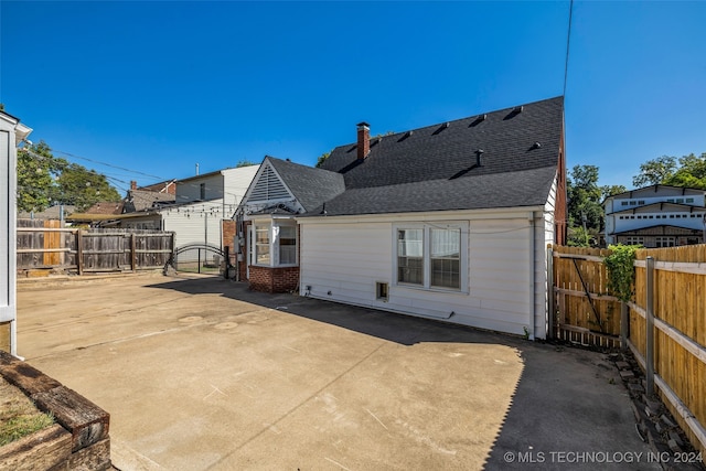 rear view of property featuring a patio area