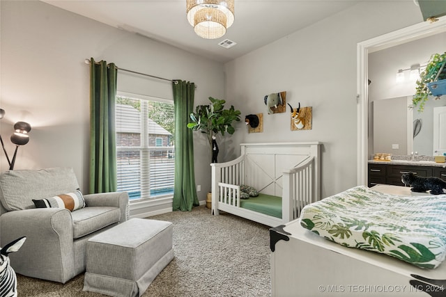 carpeted bedroom with sink and multiple windows