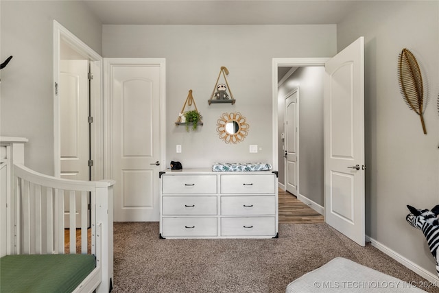 carpeted bedroom with a nursery area