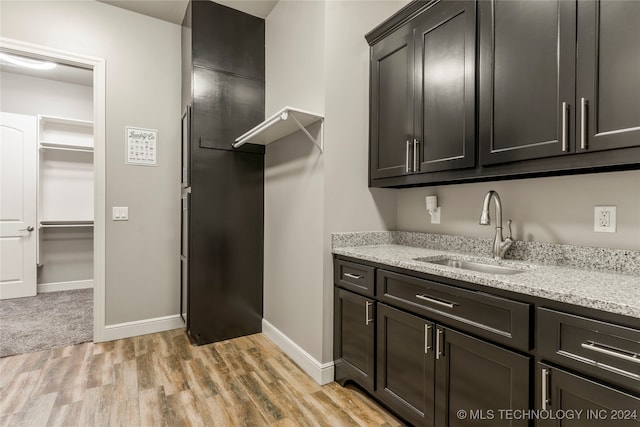 laundry room featuring sink and light wood-type flooring