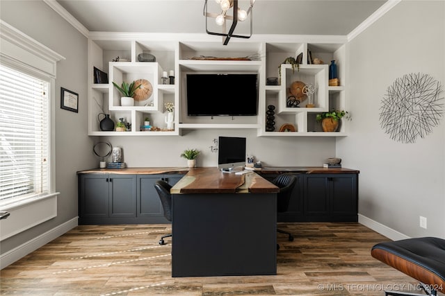 office with a notable chandelier, a healthy amount of sunlight, light hardwood / wood-style floors, and ornamental molding