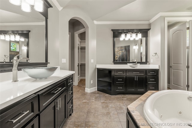 bathroom featuring vanity, ornamental molding, a tub, and vaulted ceiling