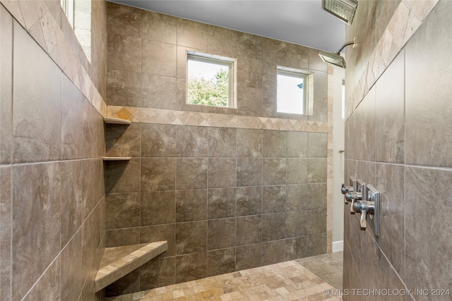 bathroom with a tile shower