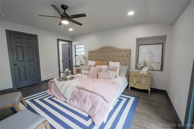 bedroom featuring dark hardwood / wood-style flooring, ceiling fan, and lofted ceiling