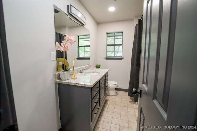 bathroom with tile patterned floors, vanity, and toilet