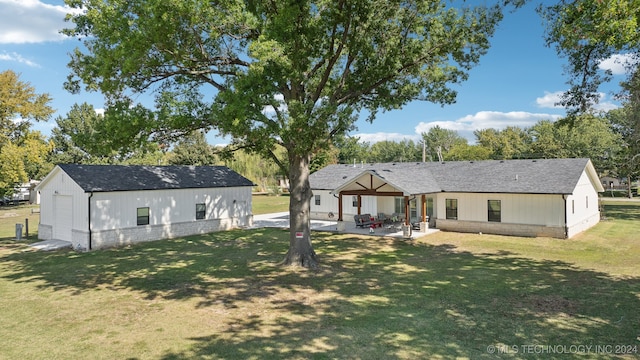 rear view of house with a patio and a yard