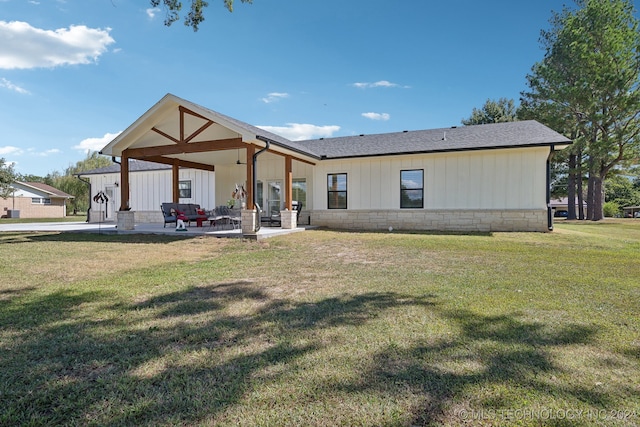 view of front of home with a front lawn, ceiling fan, and a patio area