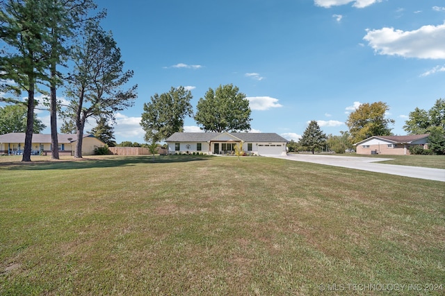 view of front of home featuring a garage and a front lawn