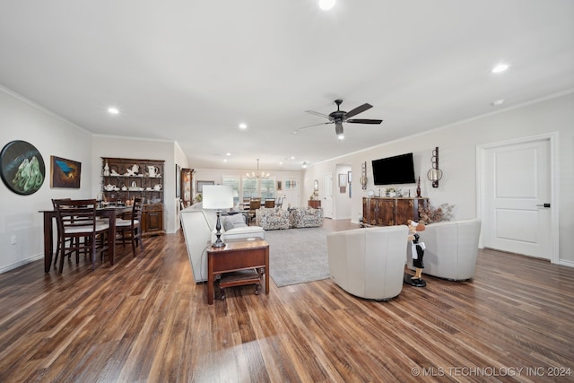 living room featuring ceiling fan with notable chandelier, crown molding, and wood-type flooring