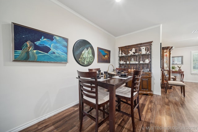 dining area featuring ornamental molding and dark hardwood / wood-style floors