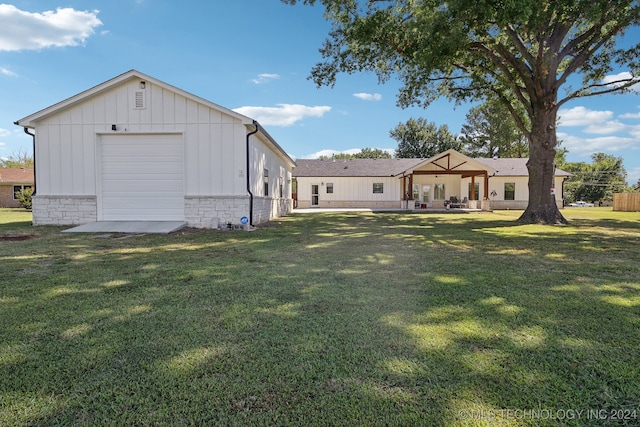 exterior space with a yard and a garage