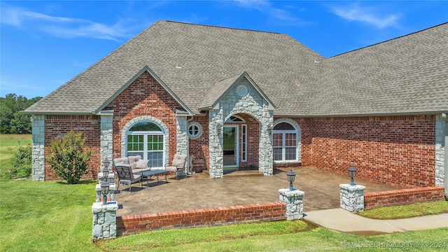 view of front of property featuring a front lawn and a patio area