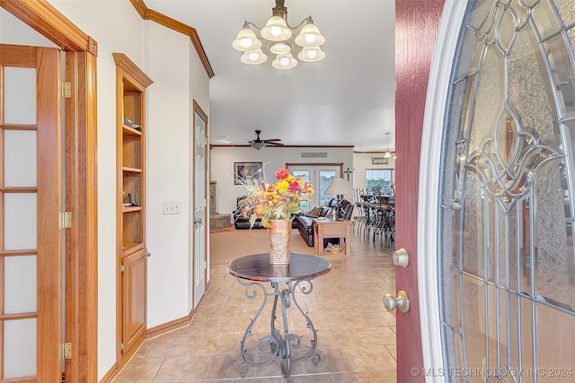 tiled foyer with ceiling fan with notable chandelier and ornamental molding