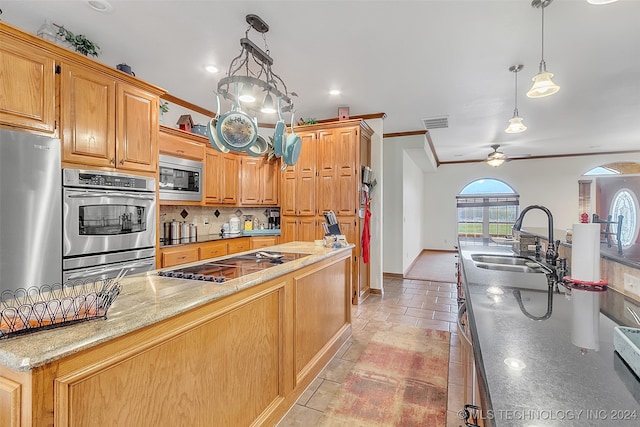 kitchen with sink, hanging light fixtures, appliances with stainless steel finishes, ornamental molding, and ceiling fan