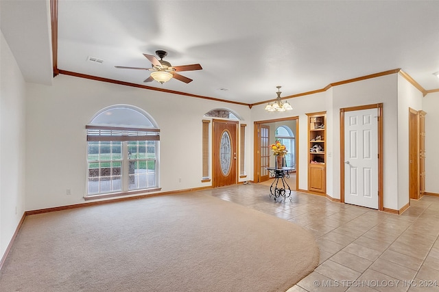 interior space with ceiling fan with notable chandelier and ornamental molding