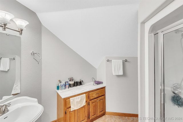 bathroom with lofted ceiling, tile patterned floors, and sink