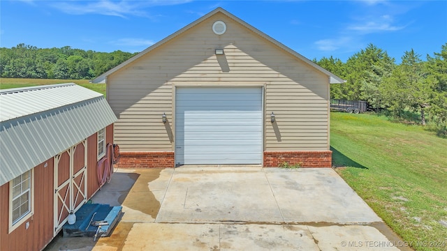 garage featuring a lawn