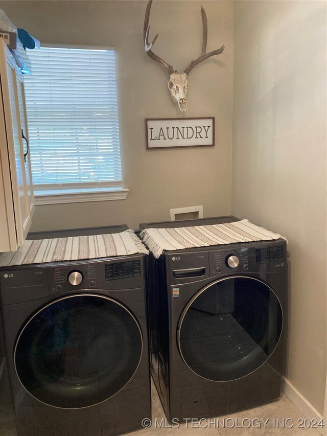 washroom with washing machine and clothes dryer