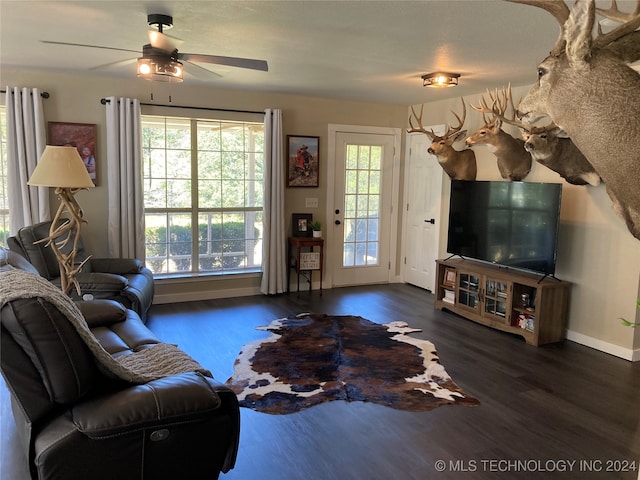 living room with dark hardwood / wood-style floors and ceiling fan