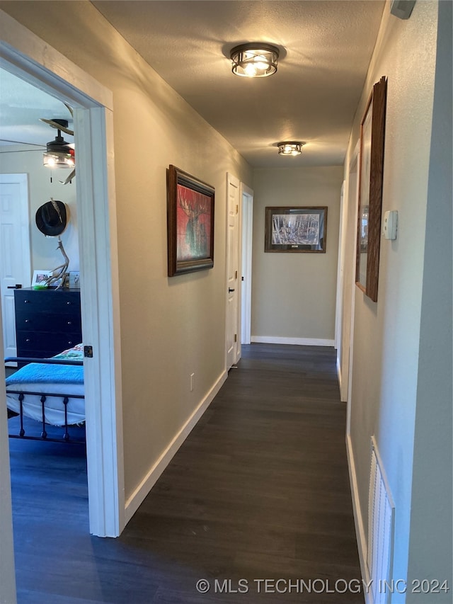 corridor featuring dark wood-type flooring