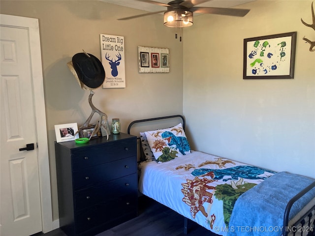 bedroom with ceiling fan and dark wood-type flooring