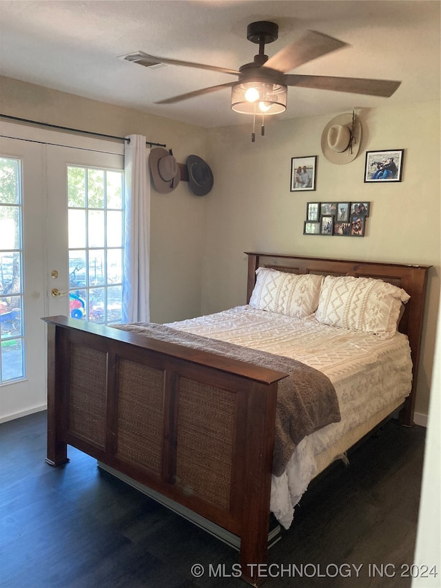 bedroom with dark hardwood / wood-style flooring and ceiling fan