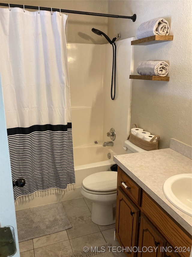 full bathroom featuring shower / bath combo with shower curtain, tile patterned flooring, vanity, and toilet